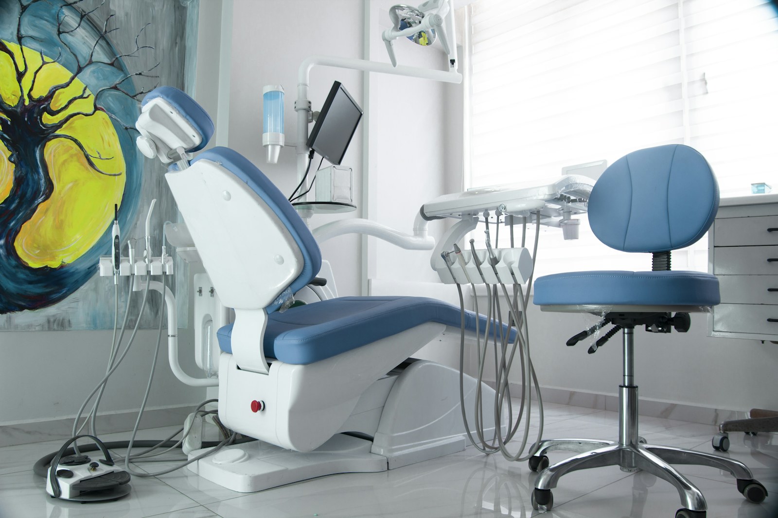 A bright, modern dental treatment room prepared for a patient